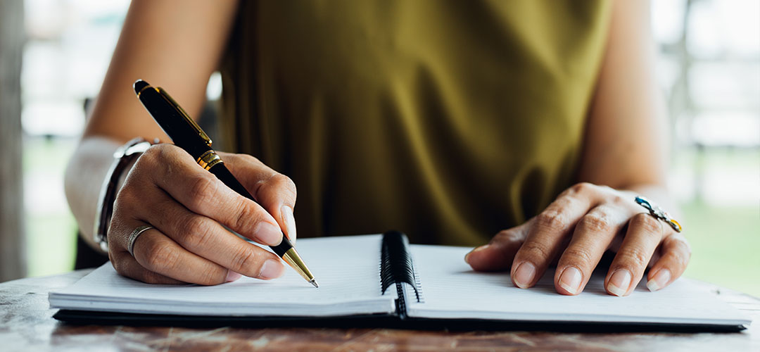 blog-featured-corrective_distributions-1080x500 Woman writing in notebook