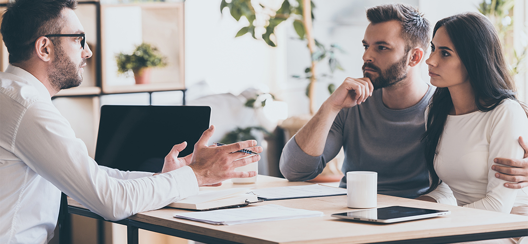 couple speaking with financial advisor