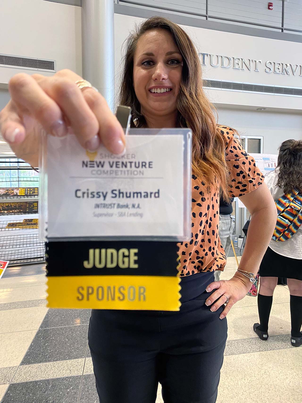 Shumard displays her judge and sponsor badge.