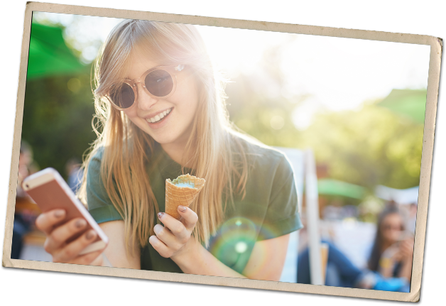 photo-mobile_banking_girl-628x431 A young woman holding a mobile phone and ice cream cone