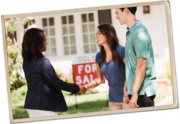 photo-mortgage_sold-628x431 A young couple shakes hands with a real estate agent in front of a For Sale sign.