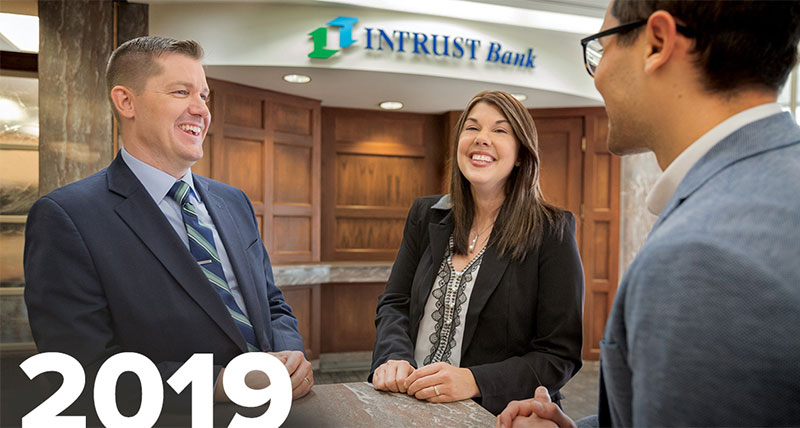 Image of INTRUST Employees laughing inside bank center